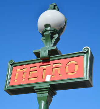 PARIS  FRANCE:  Classic Metro entrance sign for the Metropolitain underground railway system. The metro transports annually millions of inhabitants and tourists. 