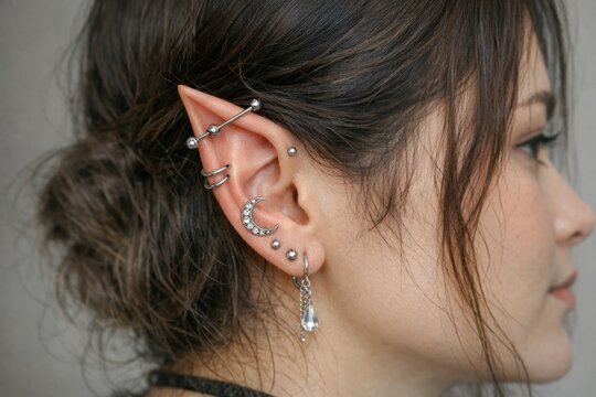 Close-up shot of a person with ear piercings, great for editorial or advertising use