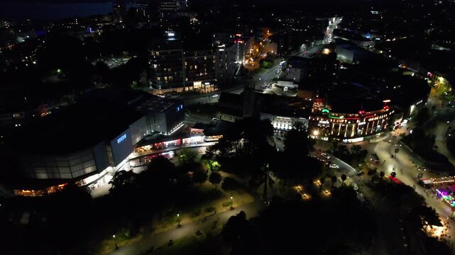 High Angle Night Footage of Illuminated Buildings and Roads with Traffic at Best Tourist Attraction Destination of England at Bournemouth City with Sandy Beach and Ocean of Great Britain, 
