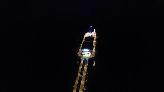 High Angle Night Footage of Illuminated Buildings and Roads with Traffic at Best Tourist Attraction Destination of England at Bournemouth City with Sandy Beach and Ocean of Great Britain, 