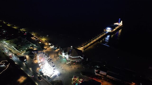 High Angle Night Footage of Illuminated Buildings and Roads with Traffic at Best Tourist Attraction Destination of England at Bournemouth City with Sandy Beach and Ocean of Great Britain, 
