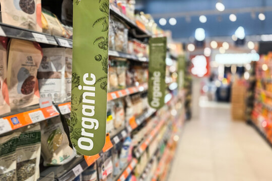 Organic word signage on supermarket packaged food aisle rack for healthy living