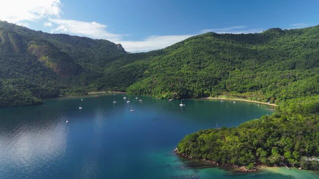 Aerial view of the calm and green lagoon with sailing boats on the island of Ilha Grande, Brazil