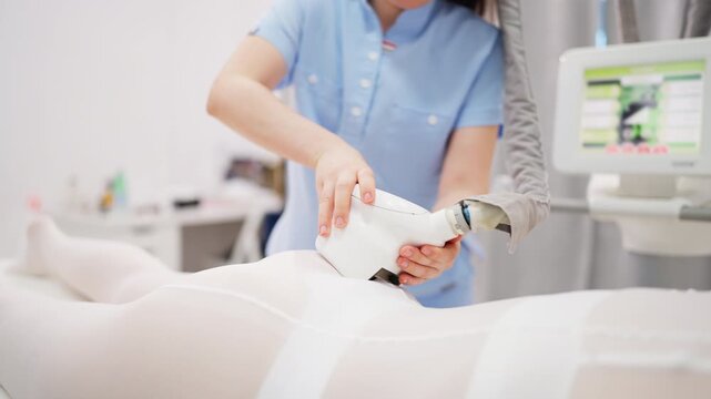 Female client receiving lpg vacuum roller massage on thighs and buttocks during professional beauty treatment for body shaping, skin care, wellness and aesthetic contouring