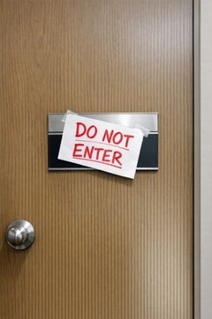 Warning sign on a dark door