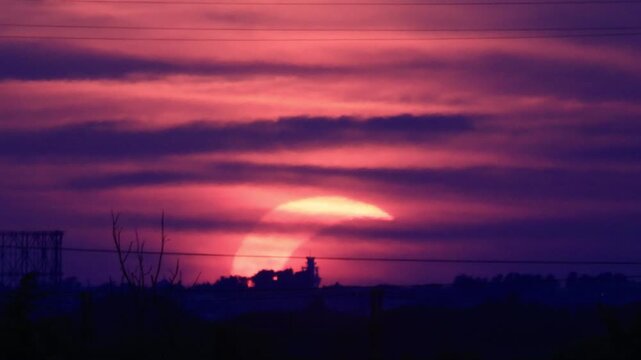 Partial solar eclipse at sunset over Rome skyline with Gasometer silhouette. Clip 06 - Sequence.