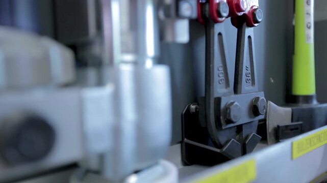 Close-up of a heavy duty bolt cutter stored in a german fire truck equipment compartment