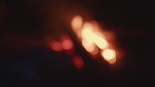 Bonfire burns in the wild area. Naturally blurred out of focus footage