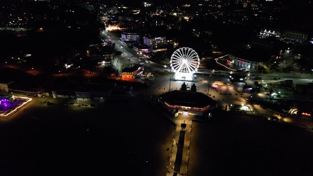 High Angle Night Footage of Illuminated Buildings and Roads with Traffic at Best Tourist Attraction Destination of England at Bournemouth City with Sandy Beach and Ocean of Great Britain, 