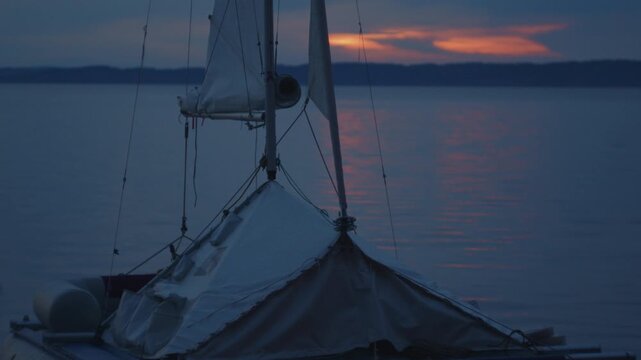 Sailing boat beached on the wild area on the lake during evening time