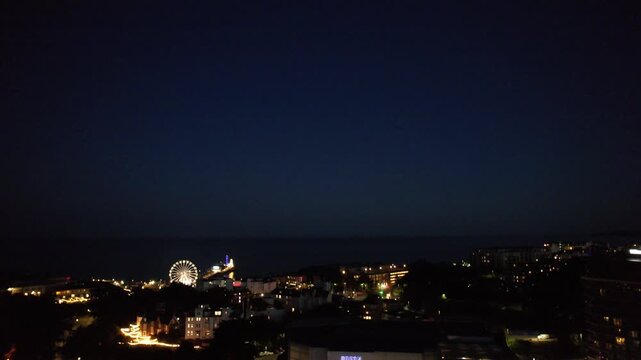 High Angle Night Footage of Illuminated Buildings and Roads with Traffic at Best Tourist Attraction Destination of England at Bournemouth City with Sandy Beach and Ocean of Great Britain, 
