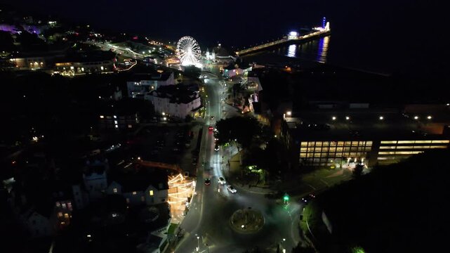 High Angle Night Footage of Illuminated Buildings and Roads with Traffic at Best Tourist Attraction Destination of England at Bournemouth City with Sandy Beach and Ocean of Great Britain, 