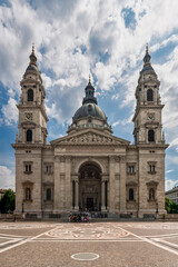 Fototapeta premium Full frontal facade of Saint Stephen's Basilica with twin bell towers and patterned pavement in Budapest
