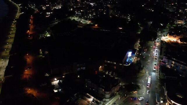 High Angle Night Footage of Illuminated Buildings and Roads with Traffic at Best Tourist Attraction Destination of England at Bournemouth City with Sandy Beach and Ocean of Great Britain, 
