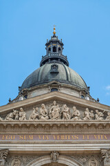 Sculpted pediment relief above the Latin inscription on the facade of Saint Stephen's Basilica in Budapest, Hungary © GuillaumeAngleraud