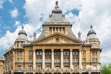 Symmetrical front facade of Anker Palace with columns and corner turrets in central Budapest, Hungary © GuillaumeAngleraud