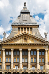 Fototapeta premium Central tower and classical portico of weathered Anker Palace at Deak Ferenc Square in Budapest, Hungary