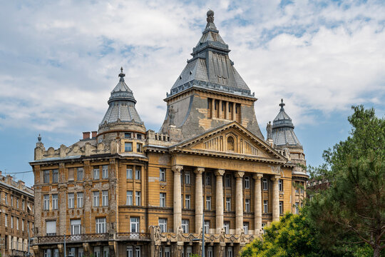 Full facade of Anker Palace with metal-clad towers and classical columns in central Budapest, Hungary