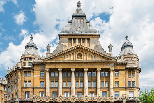 Symmetrical front facade of Anker Palace with columns and corner turrets in central Budapest, Hungary