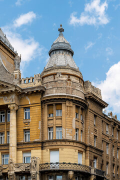 Rounded corner turret and weathered facade of Anker Palace in the Terezvaros district of Budapest, Hungary