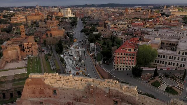 Aerial 4K video footage of Roman Colosseum at sunrise. Ancient amphitheater bathed in golden light.