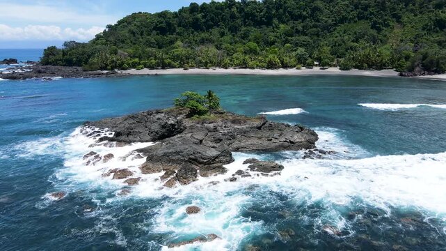 Drone Approach to San Josecito Beach Over Rocky Offshore Islet with Breaking Waves, Osa Peninsula, Costa Rica.