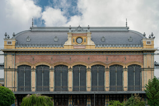 Main historic facade and monumental iron-framed windows of Nyugati Railway Station in central Budapest, Hungary