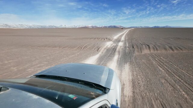 Offroad SUV Pick Up Truck driving through Campo de Piedra Pomez in Catamarca Argentina Front Hood POV sunrise - Drone flying, Aerial view