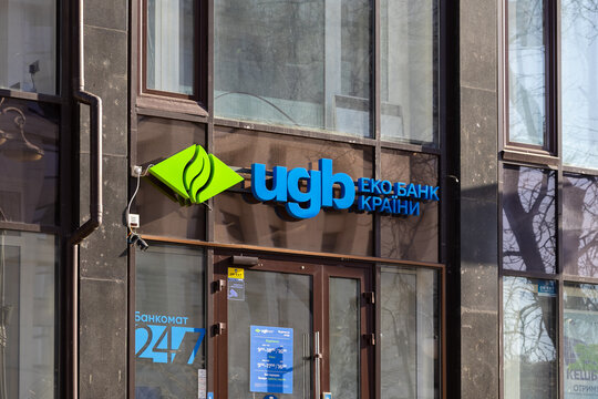 Kyiv, Ukraine - March 15, 2026: A prominent UGB Bank sign mounted on a modern glass facade in a bustling urban setting, showcasing professional financial branding and logo design