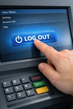 A man presses the logout button on an ATM machine, capturing the moment of security and finance