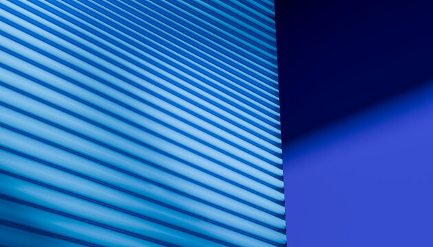 Close-up of blue exterior window shutters casting shadows on a blue