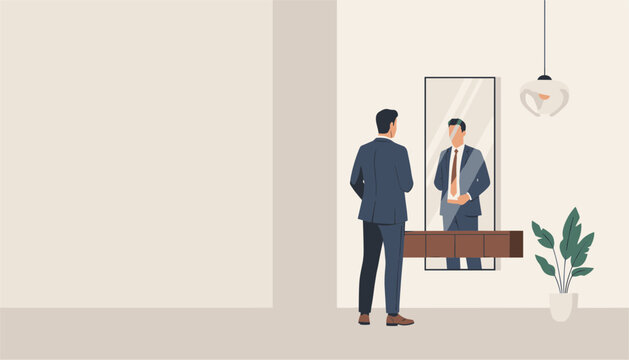 Businessman in a stylish navy suit checks his reflection in a full length mirror in a modern minimalist hallway.
