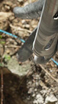 Heavy core drilling equipment pulling up stone sample during geological exploration. Macro vertical shot.