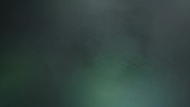 Dark green textured background with subtle lighting and soft gradient vignette
