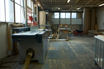 Industrial carpentry space features equipment. Rustic woodworking area with practical fixtures