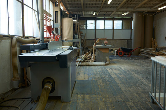 Industrial carpentry space features equipment. Rustic woodworking area with practical fixtures