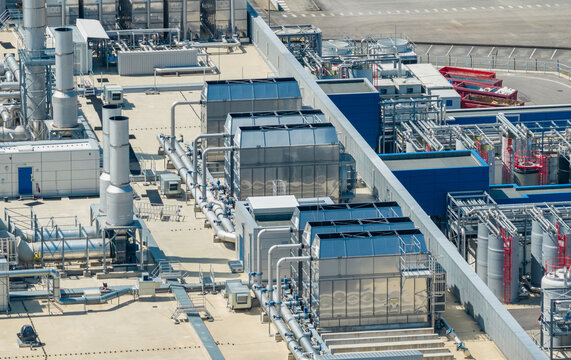 Crolles, France - 01 August 2026: Aerial view of the STMicroelectronics semiconductor manufacturing complex, featuring industrial cooling towers, piping networks, and technical infrastructure.