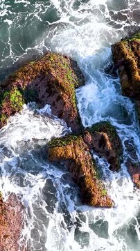 Arma&ccedil;&atilde;o Beach in Florian&oacute;polis, Brazil. Waves Crashing Against Coastal Rocks in Slow Motion. Aerial View. Vertical video