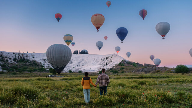 Ballooning above the stunning travertine terraces of Pamukkale in Turkey at sunrise