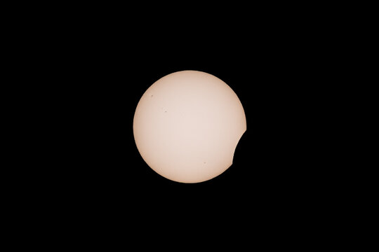 First contact as the moon passes in front of the sun during the solar eclipse in August 2026 over northern span
