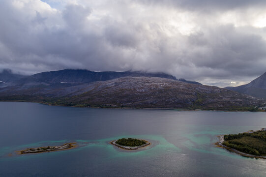 Small islands and turquoise shallows in mountainous Efjord