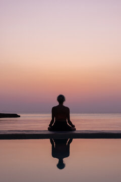 mindfulness, silhouette of woman practicing meditation at sunset