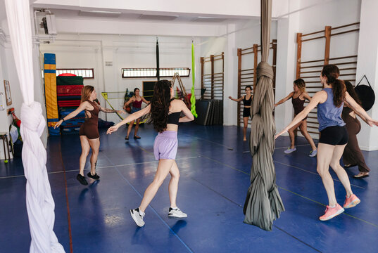 Women training aerial dance in fitness studio