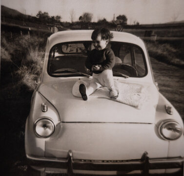 UGC analog film portrait of baby on a car