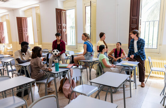 Diverse students conversing in classroom during break