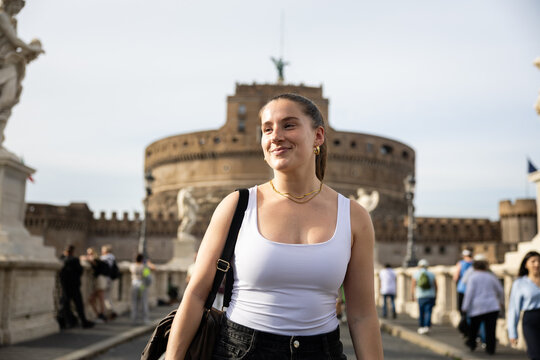 Smiling on Ponte Sant'Angelo with Castel Sant'Angelo behind