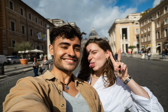 Couple taking a silly selfie near St. Peter's Basilica