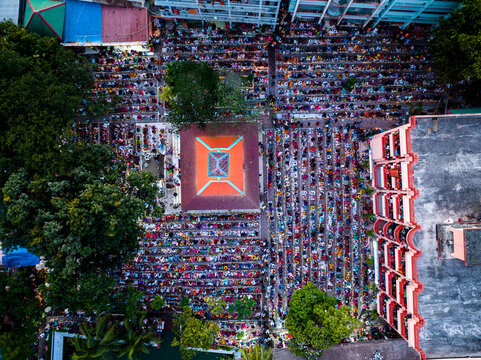 Narayanganj, Dhaka Division, Bangladesh - 09 November 2024: Aerial view of a large crowd of people gathered for prayer in an open courtyard in Narayanganj.
