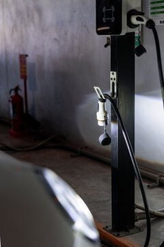 Electric vehicle charging station in a dimly lit garage.