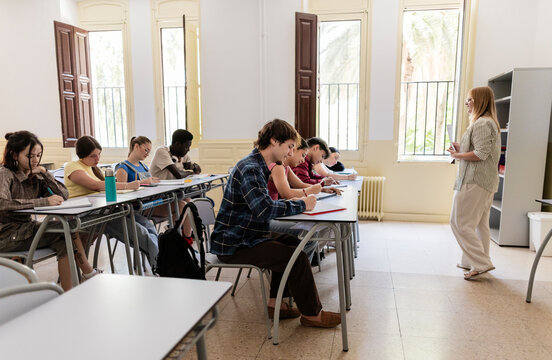 Diverse students learning in a classroom with teacher